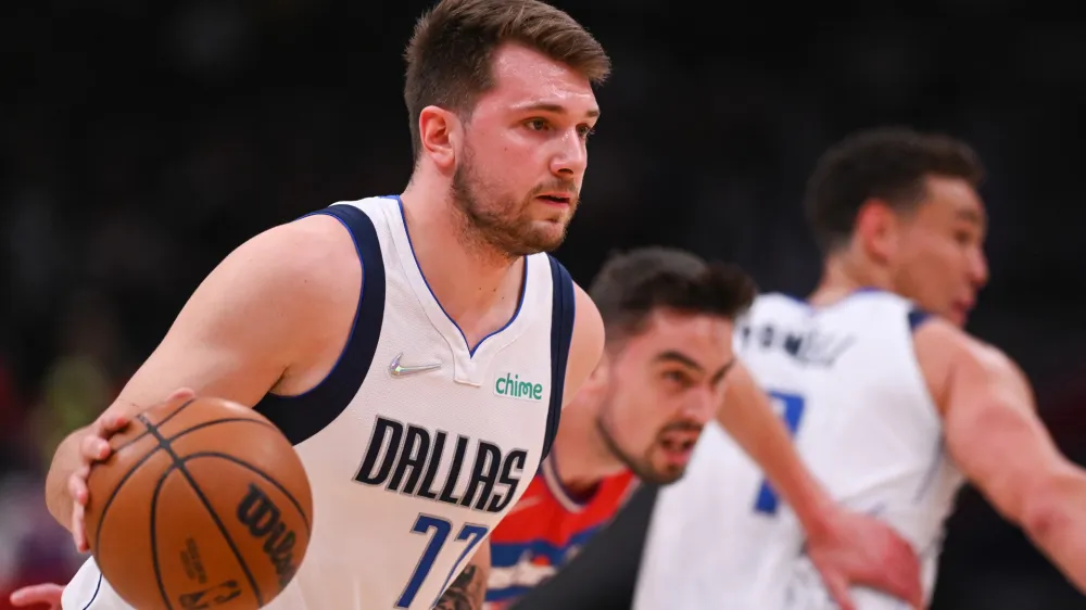 Apr 1, 2022; Washington, District of Columbia, USA;Dallas Mavericks guard Luka Doncic (77) dribble up court by Washington Wizards guard Tomas Satoransky (31) during the first half at Capital One Arena. Mandatory Credit: Tommy Gilligan-USA TODAY Sports