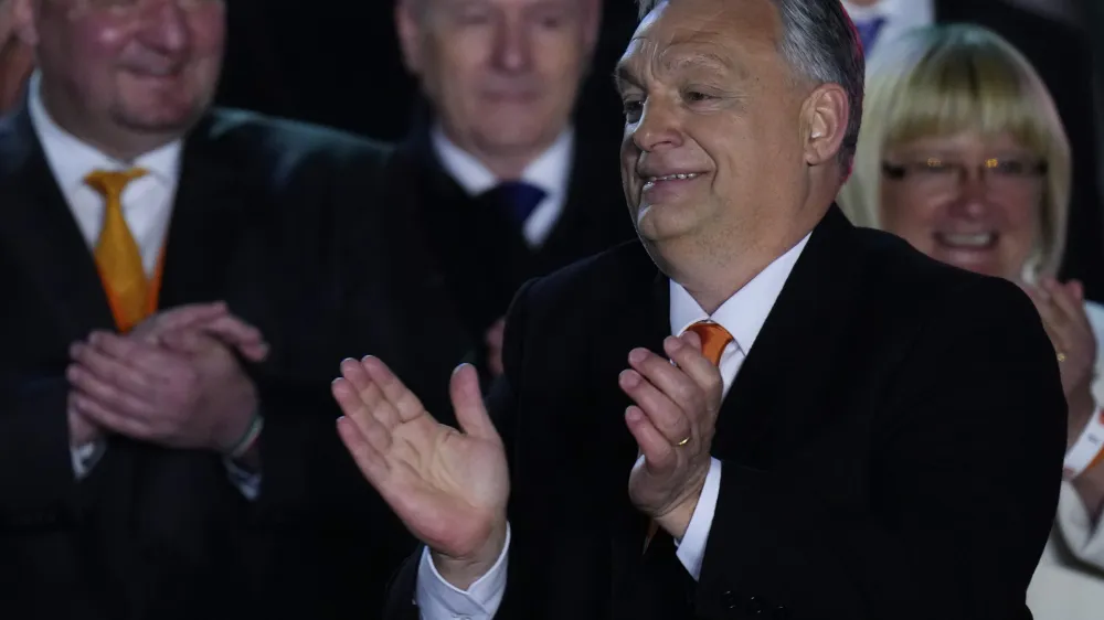 Hungary's Prime Minister Viktor Orban acknowledges cheering supporters during an election night rally in Budapest, Hungary, Sunday, April 3, 2022. Early partial results in Hungary's national election are showing a strong lead for the right-wing party of pro-Putin nationalist Orban as he seeks a fourth consecutive term. (AP Photo/Petr David Josek)