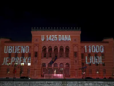 Words reading "in 1425 days over 11000 was killed" are displayed on the city hall in Sarajevo, Bosnia, Monday, April 4, 2022. Sarajevo is paying a subdued tribute to the resilience of its citizens who survived the longest military siege in modern history, and commemorating thousands of others who did not. Many of the survivors said they found the 30th anniversary of the start of the siege of the Bosnian capital particularly hard because they are marking it against the backdrop of what they describe as similar suffering being inflicted on civilians in Ukraine by Russia's occupying army. (AP Photo/Armin Durgut)