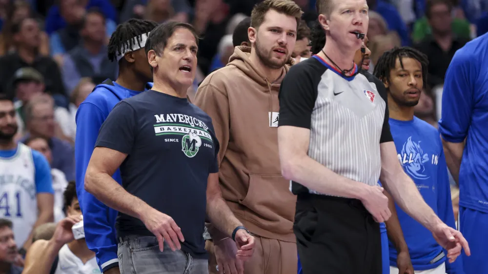 Apr 18, 2022; Dallas, Texas, USA; Dallas Mavericks injured guard Luka Doncic (77) and owner Mark Cuban speak to referee Ed Malloy (14) against the Utah Jazz during the second quarter in game two of the first round of the 2022 NBA playoffs at American Airlines Center. Mandatory Credit: Kevin Jairaj-USA TODAY Sports