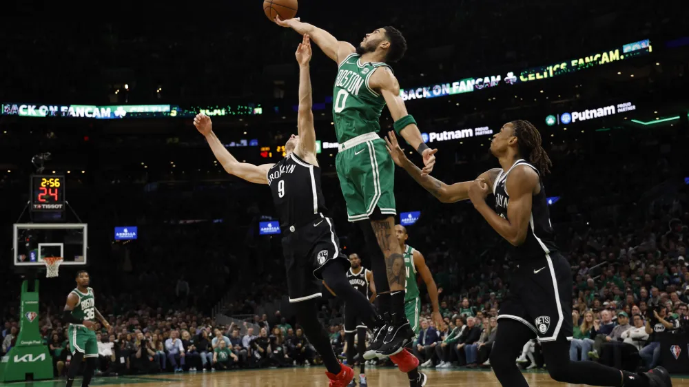 Apr 20, 2022; Boston, Massachusetts, USA; Boston Celtics forward Jayson Tatum (0) reaches for a rebound over Brooklyn Nets guard Goran Dragic (9) during the second quarter of game two of the first round of the 2022 NBA playoffs at TD Garden. Mandatory Credit: Winslow Townson-USA TODAY Sports