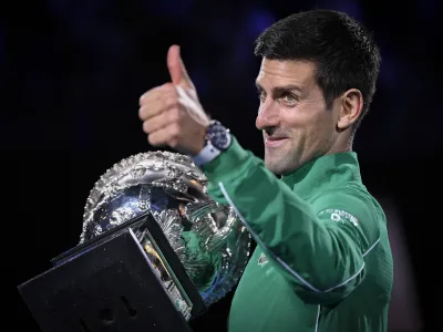 Serbia's Novak Djokovic gestures as he holds the Norman Brookes Challenge Cup after defeating Austria's Dominic Thiem in the final of the Australian Open tennis championship in Melbourne, Australia, Monday, Feb. 3, 2020. (AP Photo/Andy Brownbill)