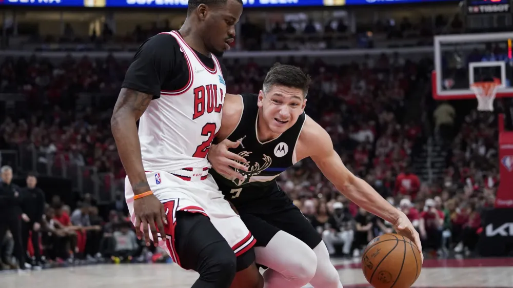 Milwaukee Bucks guard Grayson Allen, right, drives as Chicago Bulls forward Javonte Green guards during the second half of Game 4 of a first-round NBA basketball playoff series Sunday, April 24, 2022, in Chicago. (AP Photo/Nam Y. Huh)