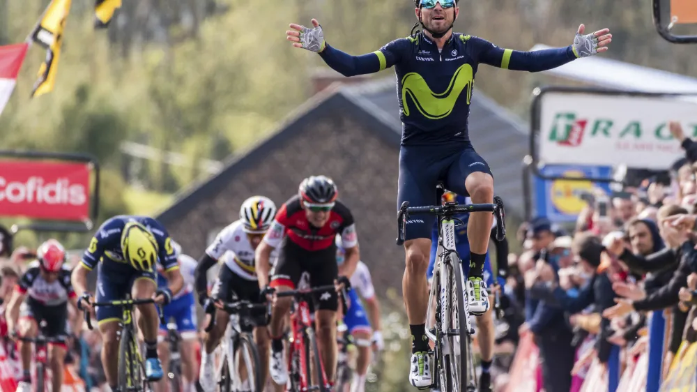 Spain's Alejandro Valverde of the Movistar team celebrates as he crosses the finish line to win the Walloon Arrow cycling race in Huy, Belgium on Wednesday April 19, 2017. Ireland's Daniel Martin of the Quick-Step finished second and Belgium's Dylan Teuns of the BMC Racing team finished third. (AP Photo/Geert Vanden Wijngaert)