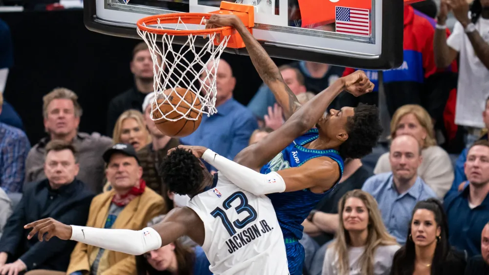 Apr 29, 2022; Minneapolis, Minnesota, USA; Minnesota Timberwolves forward Jaden McDaniels (3) dunks against the Memphis Grizzlies forward Jaren Jackson Jr. (13) in the fourth quarter during game six of the first round for the 2022 NBA playoffs at Target Center. Mandatory Credit: Brad Rempel-USA TODAY Sports
