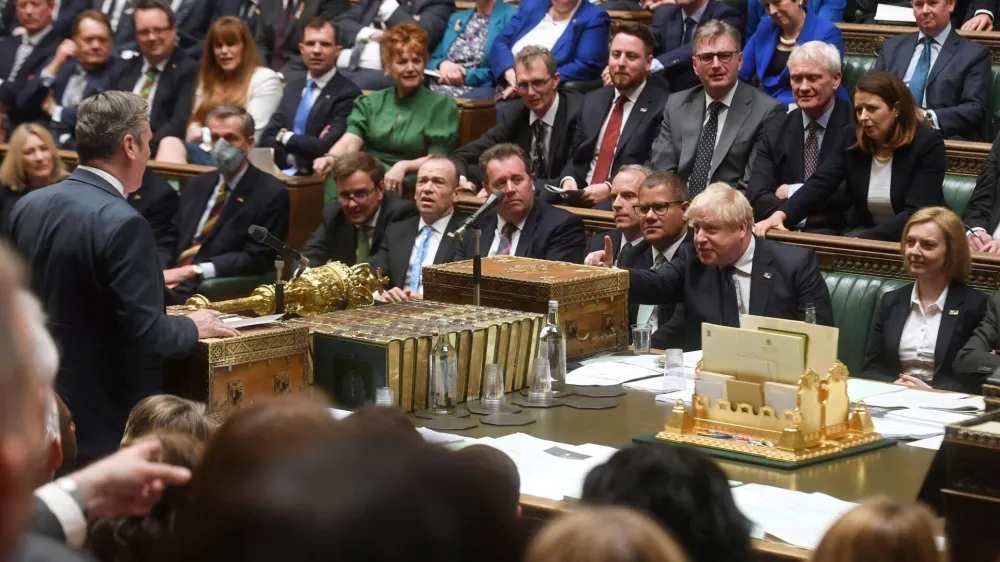 FILE PHOTO: British Prime Minister Boris Johnson gestures as Labour Party opposition leader Keir Starmer speaks during Prime Minister's Questions at the House of Commons in London, Britain April 20, 2022. UK Parliament/Jessica Taylor/Handout via REUTERS THIS IMAGE HAS BEEN SUPPLIED BY A THIRD PARTY. MANDATORY CREDIT. IMAGE MUST NOT BE ALTERED./File Photo