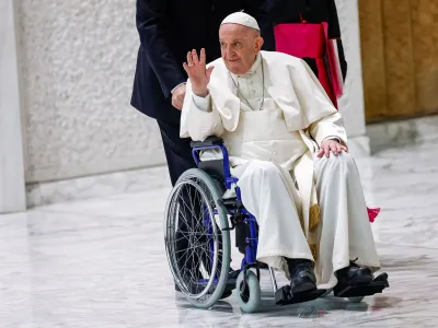 Pope Francis arrives on a wheelchair to meet with participants in the plenary assembly of the International Union of Superiors General (IUSG) at the Vatican, May 5, 2022. REUTERS/Guglielmo Mangiapane