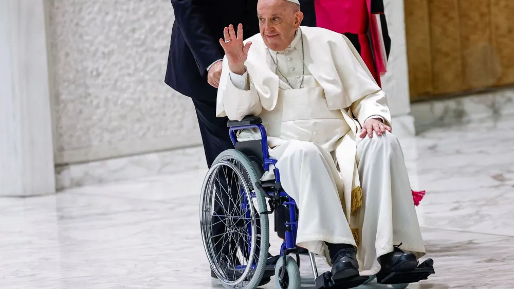 Pope Francis arrives on a wheelchair to meet with participants in the plenary assembly of the International Union of Superiors General (IUSG) at the Vatican, May 5, 2022. REUTERS/Guglielmo Mangiapane