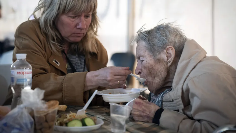 FILE - People have a meal after arriving from the Ukrainian city of Mariupol at a center for displaced people in Zaporizhzhia, Ukraine, Tuesday, May 3, 2022. With the evacuation of some civilians from a sprawling steel mill besieged by Russian forces, attention is turning to the fate of hundreds of Ukrainian troops still inside after weeks in the warren of underground tunnels and bunkers. (AP Photo/Evgeniy Maloletka)