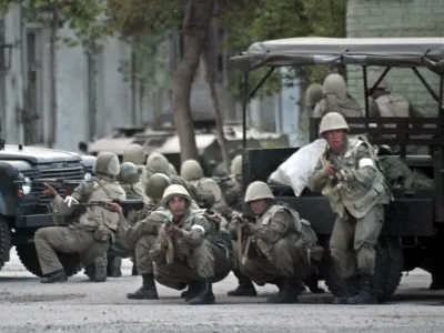 Uzbek soldiers take positions in downtown Andijan, Uzbekistan, Friday, May 13, 2005, to disperse protesters massed on the square outside the administration building. Soldiers opened fire on thousands of protesters in eastern Uzbekistan on Friday after demonstrators stormed a jail to free 23 men accused of Islamic extremism. A protest leader said about 50 people may have been killed hours earlier clashes with police and security forces. (AP Photo/Efrem Lukatsky) 