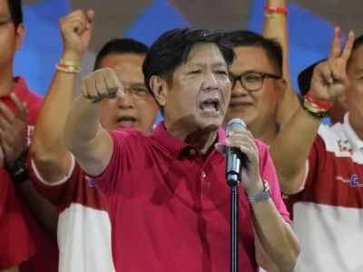 Presidential hopeful, former senator Ferdinand "Bongbong" Marcos Jr., the son of the late dictator, gestures as he greets the crowd during a campaign rally in Quezon City, Philippines on April 13, 2022. The winner of May 9, Monday's vote will inherit a sagging economy, poverty and deep divisions, as well as calls to prosecute outgoing leader Rodrigo Duterte for thousands of deaths as part of a crackdown on illegal drugs. (AP Photo/Aaron Favila)