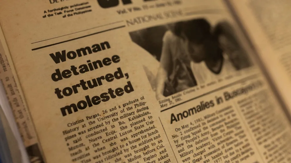 A newspaper with an article about Cristina Bawagan's arrest, torture and sexual abuse during the late Philippines' dictator Ferdinand Marcos's brutal era of martial law, is photographed in her home in Quezon City, Metro Manila, Philippines, April 22, 2022. Picture taken April 22, 2022. REUTERS/Eloisa Lopez
