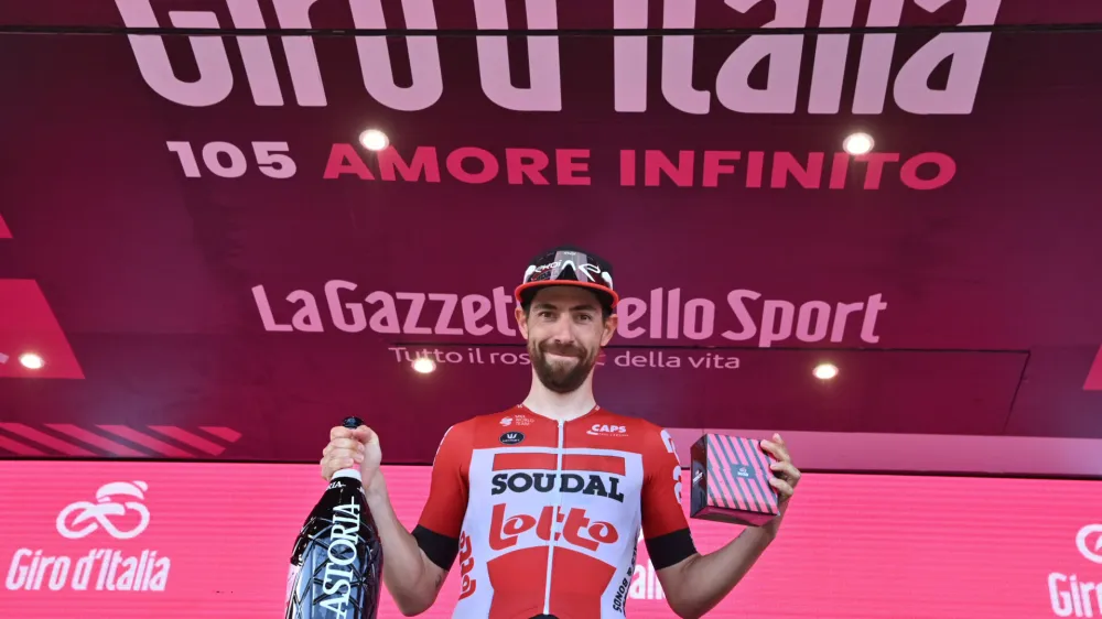 Belgium's Thomas De Gendt celebrates on the podium after winning the eighth stage of the Giro d'Italia cycling race, from Naples to Naples, Italy, Saturday, May 14, 2022. (Massimo Paolone/LaPresse via AP)