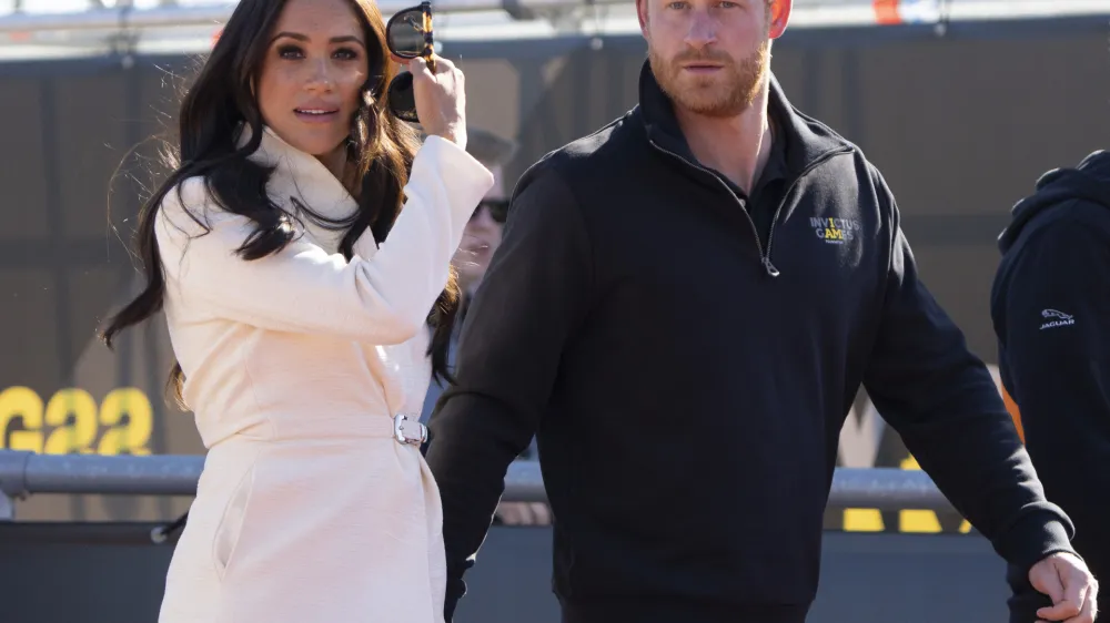 Prince Harry and Meghan Markle, Duke and Duchess of Sussex visit the track and field event at the Invictus Games in The Hague, Netherlands, Sunday, April 17, 2022. The week-long games for active servicemen and veterans who are ill, injured or wounded opened Saturday in this Dutch city that calls itself the global center of peace and justice. (AP Photo/Peter Dejong)