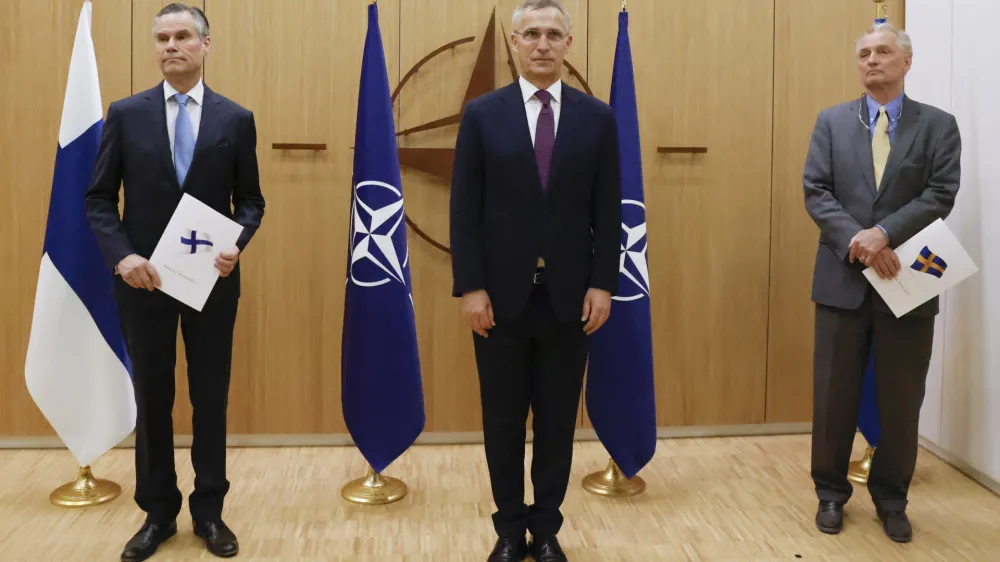Finland's Ambassador to NATO Klaus Korhonen, left, NATO Secretary-General Jens Stoltenberg and Sweden's Ambassador to NATO Axel Wernhoff attend a ceremony to mark Sweden's and Finland's application for membership in Brussels, Belgium, Wednesday May 18, 2022. NATO Secretary-General Jens Stoltenberg said that the military alliance stands ready to seize a historic moment and move quickly on allowing Finland and Sweden to join its ranks, after the two countries submitted their membership requests. (Johanna Geron/Pool via AP)