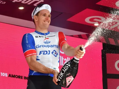 Cycling - Giro d'Italia - Stage 13 - Sanremo to Cuneo, Italy - May 20, 2022 Groupama - FDJ's Arnaud Demare celebrates after winning stage 13 on the podium REUTERS/Jennifer Lorenzini