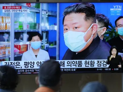 FILE - People watch a TV screen showing a news program reporting with an image of North Korean leader Kim Jong Un, at a train station in Seoul, South Korea on May 16, 2022. North Korea said Friday, May 20, that nearly 10% of its 26 million people have fallen ill and 65 people have died amid its first COVID-19 outbreak, as outside experts question the validity of its reported fatalities and worry about a possible humanitarian crisis. (AP Photo/Lee Jin-man, File)