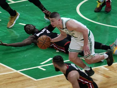 Miami Heat guard Victor Oladipo (4) looks toward officials for a call as Boston Celtics guard Payton Pritchard heads downcourt during the second half of Game 4 of the NBA basketball playoffs Eastern Conference finals, Monday, May 23, 2022, in Boston. (AP Photo/Charles Krupa)