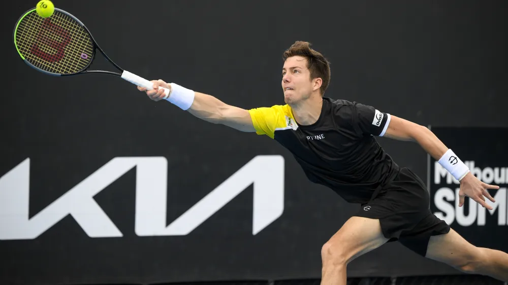 Slovenia's Aljaz Bedene makes a forehand return to Japan's Yasutaka Uchiyama during a tuneup tournament ahead of the Australian Open tennis championships in Melbourne, Australia, Monday, Feb. 1, 2021. (AP Photo/Andrew Brownbill)