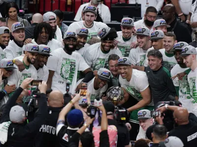 The Boston Celtics pose with the NBA Eastern Conference trophy after defeating the Miami Heat in Game 7 of the NBA basketball Eastern Conference finals playoff series, Sunday, May 29, 2022, in Miami. (AP Photo/Wilfredo Lee)
