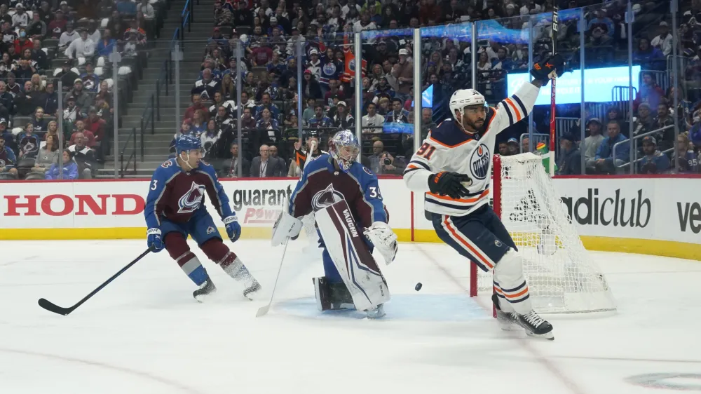 Edmonton Oilers left wing Evander Kane (91) celebrates a goal against Colorado Avalanche goaltender Darcy Kuemper (35) during the first period in Game 1 of the NHL hockey Stanley Cup playoffs Western Conference finals Tuesday, May 31, 2022, in Denver. (AP Photo/Jack Dempsey)