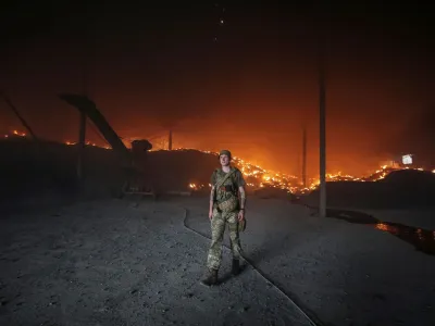 A Ukrainian serviceman walks as seeds burn in a grain silos after it was shelled repeatedly, amid Russia's invasion of Ukraine, in Donetsk region, Ukraine May 31, 2022. REUTERS/Serhii Nuzhnenko