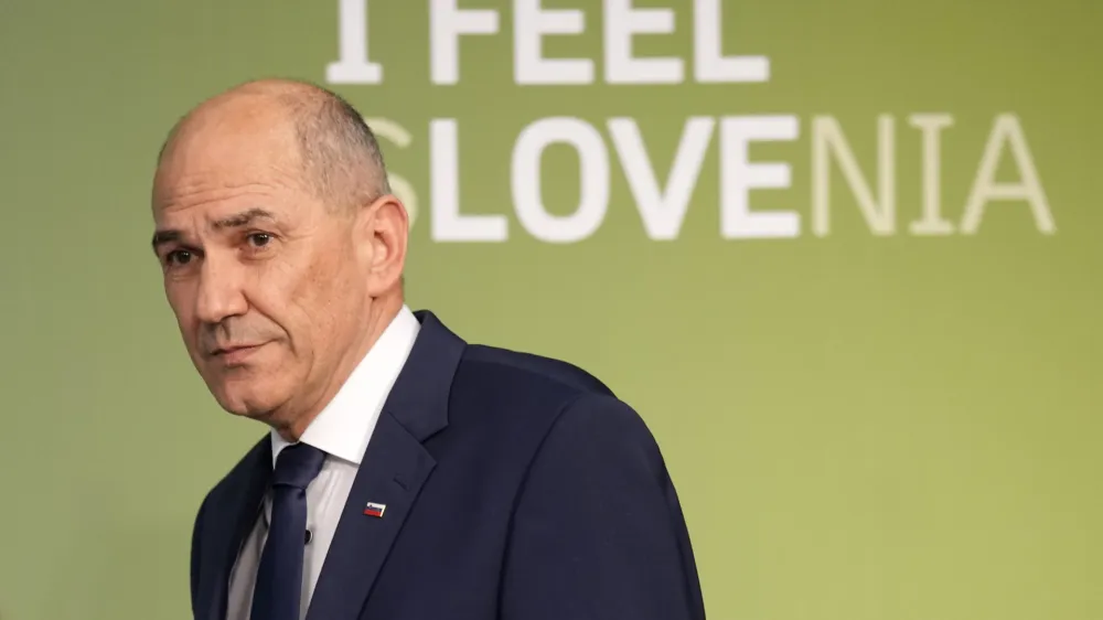 Outgoing Slovenian Prime Minister Janez Jansa walks on a stage to address the media in Ljubljana, Slovenia, Sunday, April 24, 2022. Early official results of Sunday's parliamentary election in Slovenia show that an opposition liberal party convincingly won, in a major defeat for populist Prime Minister Janez Jansa, who was accused of pushing the small European Union country to the right while in office. (AP Photo/Darko Bandic)