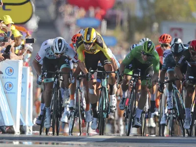 Australia's Caleb Ewan, right, goes to wheel to wheel with Ireland's Sam Bennett as he races to the finish line to win stage 11 of the Tour de France cycling race over 167.5 kilometers from Chatelaillon-Plage to Poitiers Wednesday, Sept. 9, 2020. At left is Slovakia's Peter Sagan who originally came in second place, but was disqualified for a clash with Belgium's Wout Van Aert, second left. (Thibault Camus/Pool)