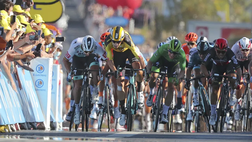 Australia's Caleb Ewan, right, goes to wheel to wheel with Ireland's Sam Bennett as he races to the finish line to win stage 11 of the Tour de France cycling race over 167.5 kilometers from Chatelaillon-Plage to Poitiers Wednesday, Sept. 9, 2020. At left is Slovakia's Peter Sagan who originally came in second place, but was disqualified for a clash with Belgium's Wout Van Aert, second left. (Thibault Camus/Pool)