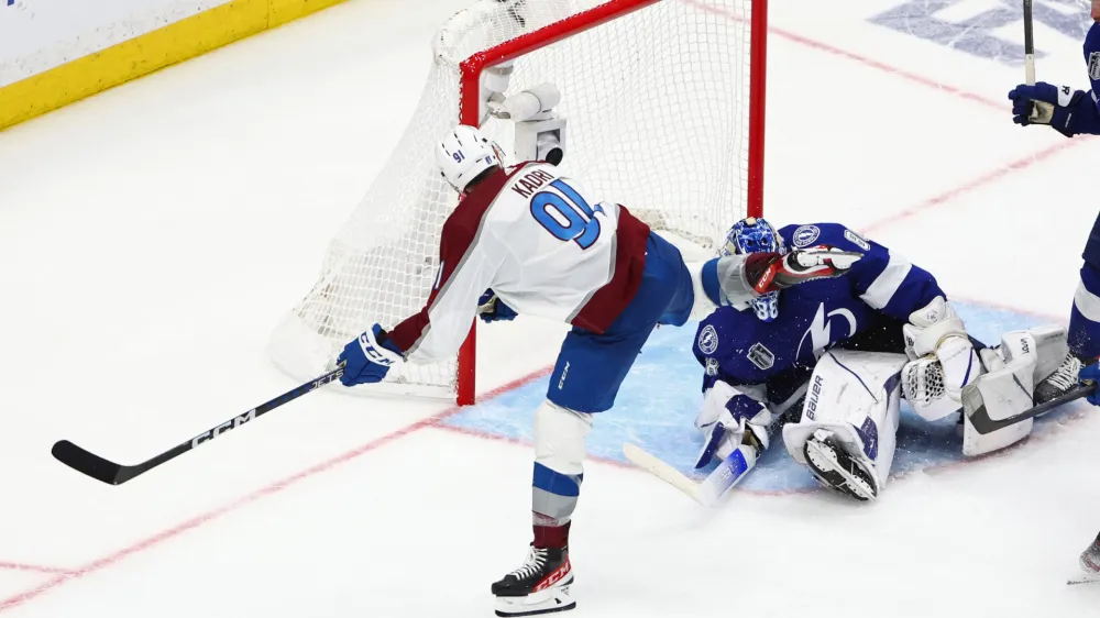 Jun 22, 2022; Tampa, Florida, USA; Colorado Avalanche center Nazem Kadri (91) scores the game winning goal against Tampa Bay Lightning goaltender Andrei Vasilevskiy (88) during overtime in game four of the 2022 Stanley Cup Final at Amalie Arena. Mandatory Credit: Mark J. Rebilas-USA TODAY Sports