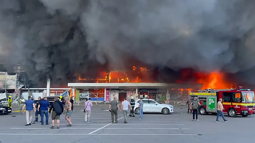 27 June 2022, Ukraine, Kremenchuk: Firefighters work to put out the fire in a mall hit by a Russian missile strike in the eastern Ukrainian city of Kremenchuk. Photo: -/ZUMA Press Wire Service/dpa