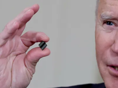 U.S. President Joe Biden holds a semiconductor chip as he speaks prior to signing an executive order, aimed at addressing a global semiconductor chip shortage, in the State Dining Room at the White House in Washington, U.S., February 24, 2021. REUTERS/Jonathan Ernst/