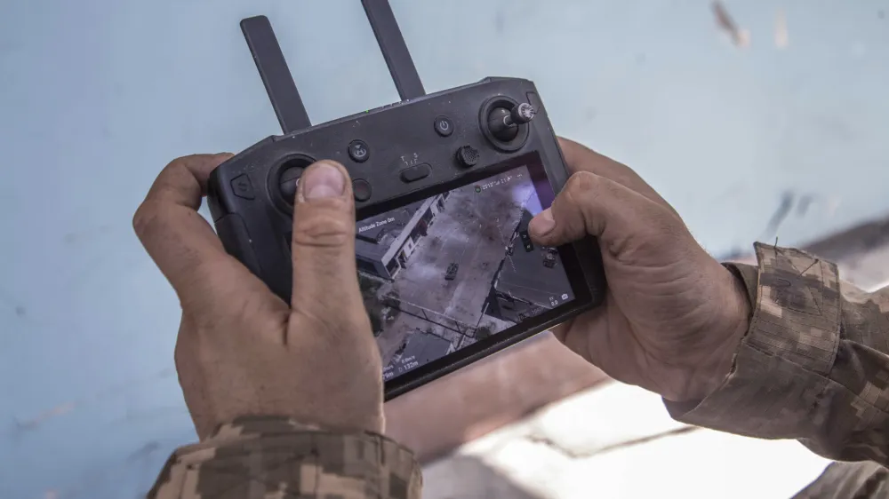 A Ukrainian soldier looks at a drone screen showing Russian troops positions during heavy fighting at the front line in Severodonetsk, Luhansk region, Ukraine, Wednesday, June 8, 2022. (AP Photo/Oleksandr Ratushniak)