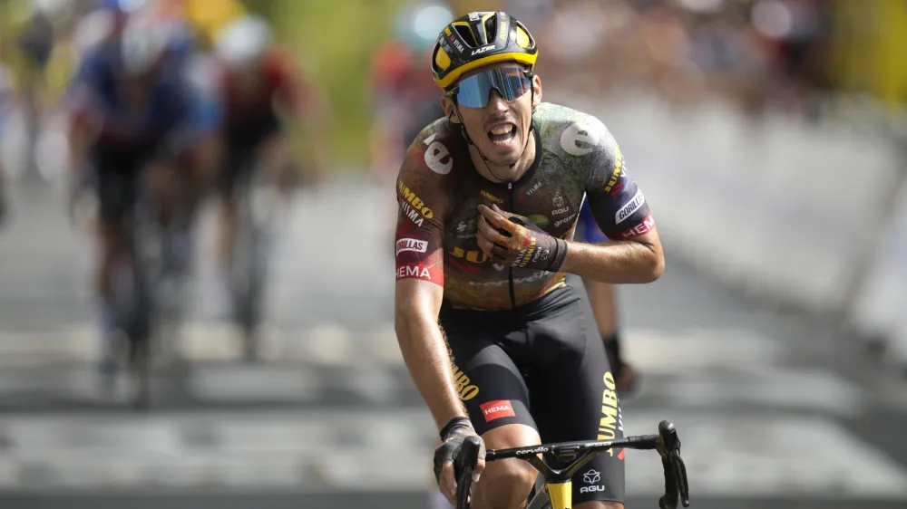 France's Christophe Laporte celebrates as he crosses the finish line to win the nineteenth stage of the Tour de France cycling race over 188.5 kilometers (117.3 miles) with start in Castelnau-Magnoac and finish in Cahors, France, Friday, July 22, 2022. (AP Photo/Daniel Cole)