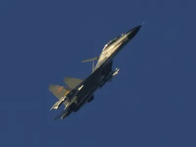 A Chinese J-11 military fighter jet flies above the Taiwan Strait near Pingtan, the closest land of mainland China to the island of Taiwan, in Pingtan in southeastern China's Fujian Province, Friday, Aug. 5, 2022. China says it is canceling or suspending dialogue with the U.S. on issues from climate change to military relations and anti-drug efforts in retaliation for a visit this week to Taiwan by U.S. House Speaker Nancy Pelosi. (AP Photo/Ng Han Guan)