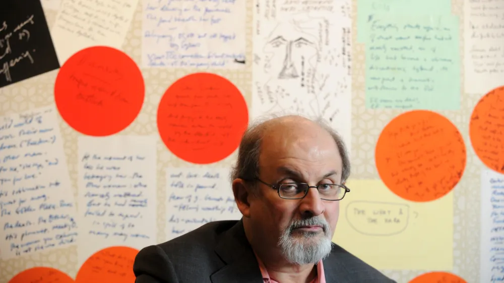 FILED - 25 February 2010, US, Atlanta: Writer Salman Rushdie poses for a picture with some of his enlarged notes at an Emory University exhibit of his work in Atlanta. Rushdie was rushed to hospital for surgery after being attacked during a literary event in New York state on Friday. Photo: Erik Lesser/ZUMApress/dpa
