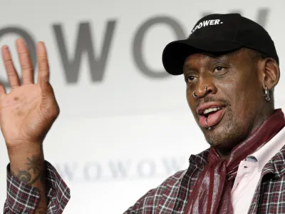FILE - In this Oct. 25, 2013, file photo, former basketball player Dennis Rodman waves during a news conference in Tokyo. The former NBA star has been charged with hit-and-run for a wrong-way-related crash on a Southern California freeway. Orange County prosecutors filed misdemeanor charges against Rodman, Monday, Nov. 21, 2016, for a July 20, 2016, accident on Interstate 5 in Santa Ana. (AP Photo/Shizuo Kambayashi, File)