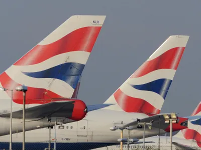 The tailfins of British Airways aircraft are seen at Heathrow Airport in west London December 14, 2009. Thousands of British Airways cabin crew voted to strike, hours after the airline revealed a 3.7 billion pound ( billion) hole in its pension fund that will require deft handling by management if a proposed merger with Iberia is to stay on track. "The strike will take place over 12 days from December 22 but we have taken the decision, which will disrupt the travel plans of thousands of people, with a heavy heart," a Unite spokesman said <br>at a press conference following the result of the ballot at Sandown Park Racecourse, west of London, on Monday.  REUTERS/Toby Melville (BRITAIN - Tags: TRANSPORT BUSINESS EMPLOYMENT TRAVEL)