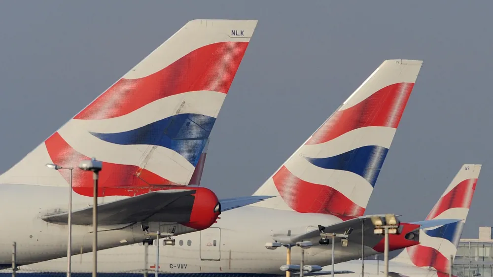 The tailfins of British Airways aircraft are seen at Heathrow Airport in west London December 14, 2009. Thousands of British Airways cabin crew voted to strike, hours after the airline revealed a 3.7 billion pound ($6 billion) hole in its pension fund that will require deft handling by management if a proposed merger with Iberia is to stay on track. "The strike will take place over 12 days from December 22 but we have taken the decision, which will disrupt the travel plans of thousands of people, with a heavy heart," a Unite spokesman said <br>at a press conference following the result of the ballot at Sandown Park Racecourse, west of London, on Monday.  REUTERS/Toby Melville (BRITAIN - Tags: TRANSPORT BUSINESS EMPLOYMENT TRAVEL)