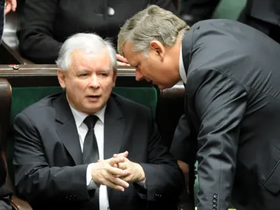 Opposition leader Jaroslaw Kaczynski, left, speaks with his lawmaker Marek Suski during the first session of the new Polish Parliament, in Warsaw, Poland, Tuesday, Nov. 8, 2011. (AP Photo/Alik Keplicz)