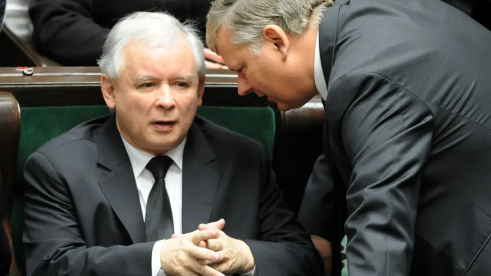 Opposition leader Jaroslaw Kaczynski, left, speaks with his lawmaker Marek Suski during the first session of the new Polish Parliament, in Warsaw, Poland, Tuesday, Nov. 8, 2011. (AP Photo/Alik Keplicz)