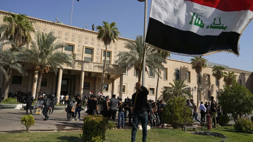 Supporters of Shiite cleric Muqtada al-Sadr demonstrate in the grounds of the Government Palace in Baghdad, Iraq, Monday, Aug. 29, 2022. Al-Sadr, a hugely influential Shiite cleric announced he will resign from Iraqi politics and his angry followers stormed the government palace in response. The chaos Monday sparked fears that violence could erupt in a country already beset by its worst political crisis in years. (AP Photo/Hadi Mizban)
