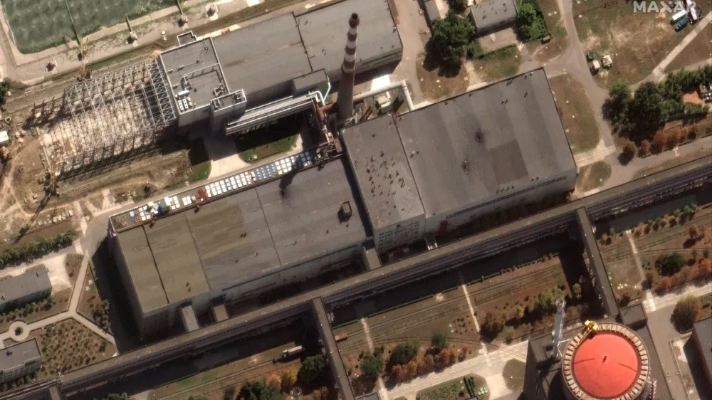 This satellite image provided by Maxar Technologies shows recent damage to the roof of a building adjacent to several of the nuclear reactors at the Zaporizhzhia nuclear plant in Russian occupied Ukraine, Monday Aug. 29, 2022. A team from the U.N. nuclear watchdog on Monday started its journey to the Zaporizhzhia atomic power plant at the heart of fighting in Ukraine, a long-awaited mission to inspect crucial safety systems that the world hopes will help avoid a catastrophe. (Satellite image ©2022 Maxar Technologies via AP)
