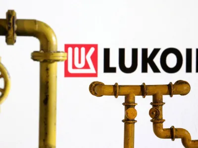 FILE PHOTO: Model of natural gas pipeline and Lukoil logo, July 18, 2022. REUTERS/Dado Ruvic/Illustration/File Photo