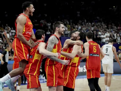 Spain's Sebas Saiz, left, and his teammates celebrate after the Eurobasket semi final basketball match between Germany and Spain in Berlin, Germany, Friday, Sept. 16, 2022. Spain defeated Germany by 96-91. (AP Photo/Michael Sohn)