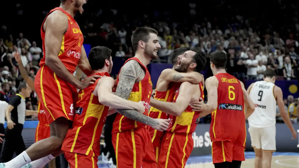Spain's Sebas Saiz, left, and his teammates celebrate after the Eurobasket semi final basketball match between Germany and Spain in Berlin, Germany, Friday, Sept. 16, 2022. Spain defeated Germany by 96-91. (AP Photo/Michael Sohn)