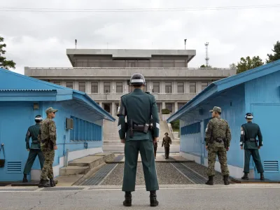 FILE - In this Sept. 30, 2013, file photo, South Korean soldiers look toward the North Korean side as a North Korean solder approaches the UN truce village building that sits on the border of the Demilitarized Zone (DMZ), the military border separating the two Koreas in Panmunjom, South Korea. The search is on for a venue to host a summit between President Donald Trump and North Korea&acirc;&euro;&trade;s Kim Jong Un. There are lots of caveats. Trump is being urged not to legitimize Kim by agreeing to talks in North Korea. And it&acirc;&euro;&trade;s risky for Kim to travel to the U.S. So the leaders are more likely to meet in a neutral place, such as the demilitarized zone between the Koreas. (AP Photo/Jacquelyn Martin, File)