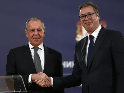 FILE - Russian Foreign Minister Sergey Lavrov, left, shakes hands with Serbia's President Aleksandar Vucic after a press conference in Belgrade, Serbia, Sunday, Oct. 10, 2021. European Union candidate Serbia has signed an agreement with Russia to hold mutual "consultations" on foreign policy matters. Serbian Foreign Affairs Minister Nikola Selakovic signed the agreement with Russian Foreign Minister Sergey Lavrov on the margins of the U.N. General Assembly. (AP Photo/Darko Vojinovic, File)