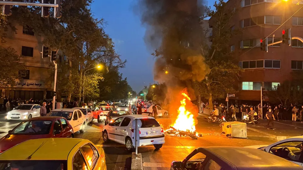 FILE PHOTO: A police motorcycle burns during a protest over the death of Mahsa Amini, a woman who died after being arrested by the Islamic republic's "morality police", in Tehran, Iran September 19, 2022. WANA (West Asia News Agency) via REUTERS ATTENTION EDITORS - THIS IMAGE HAS BEEN SUPPLIED BY A THIRD PARTY.  ATTENTION EDITORS - THIS PICTURE WAS PROVIDED BY A THIRD PARTY/File Photo