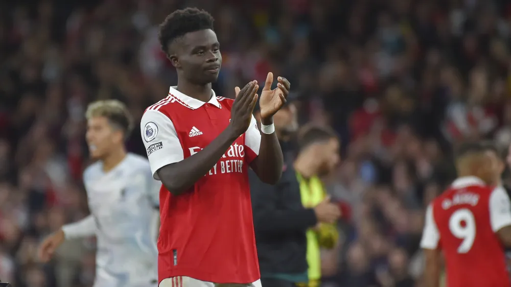 Arsenal's Bukayo Saka waves supporters at the end of the English Premier League soccer match between Arsenal and Liverpool at Emirates Stadium in London, Sunday, Oct. 9, 2022. Arsenal won 3-2. (AP Photo/Rui Vieira)